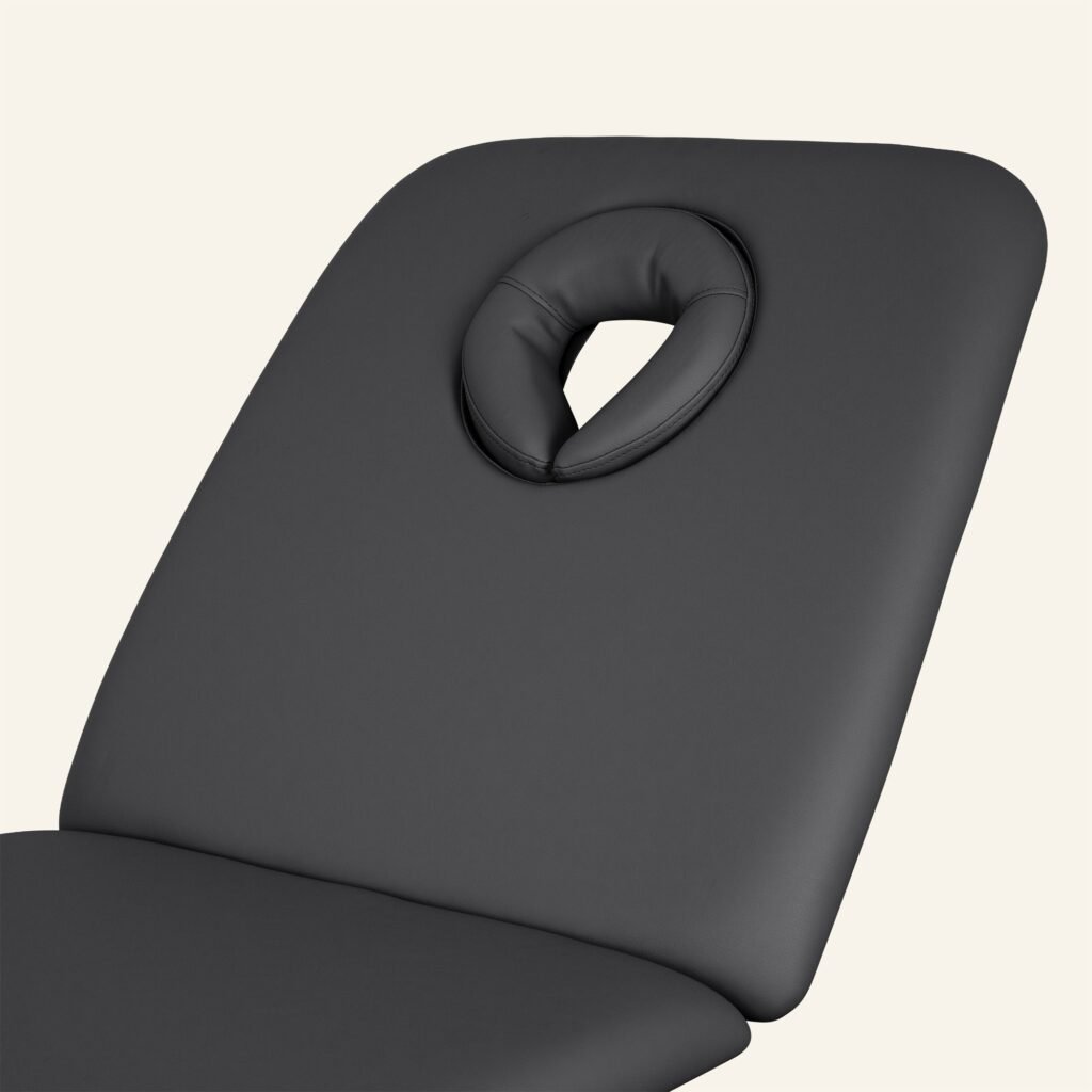 Zwarte massagetafel met gezichtskussen